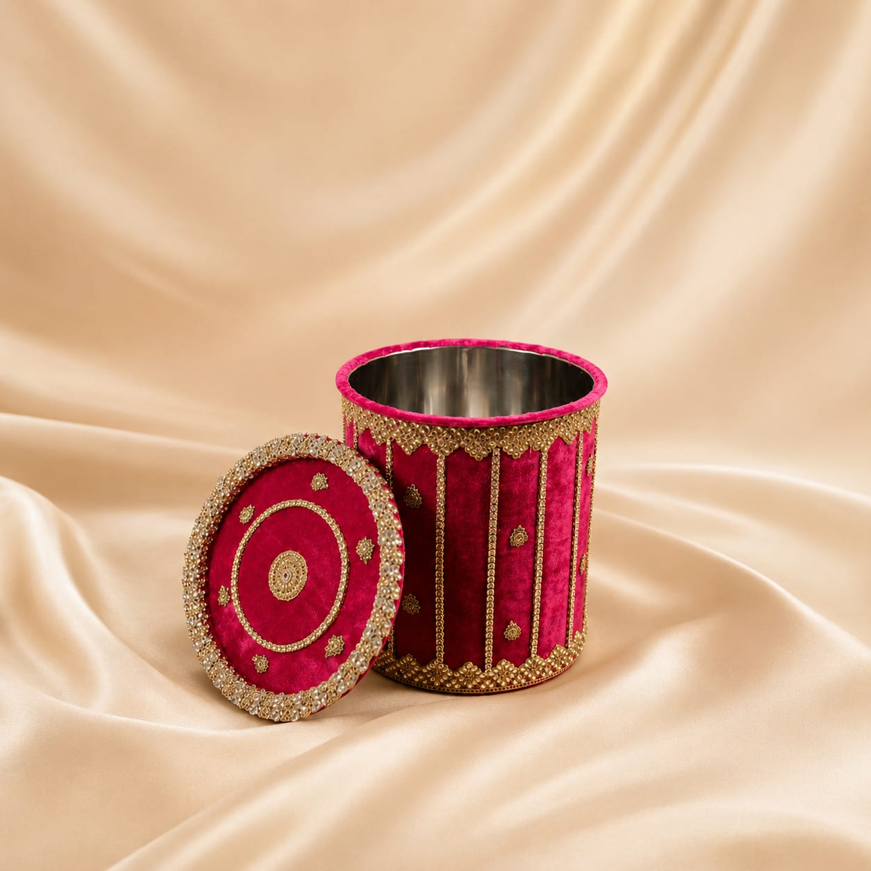 Festive embellished round dabba in yellow and red with gold sequins